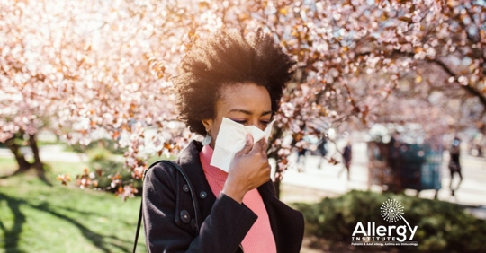 woman sneezing in spring bloom